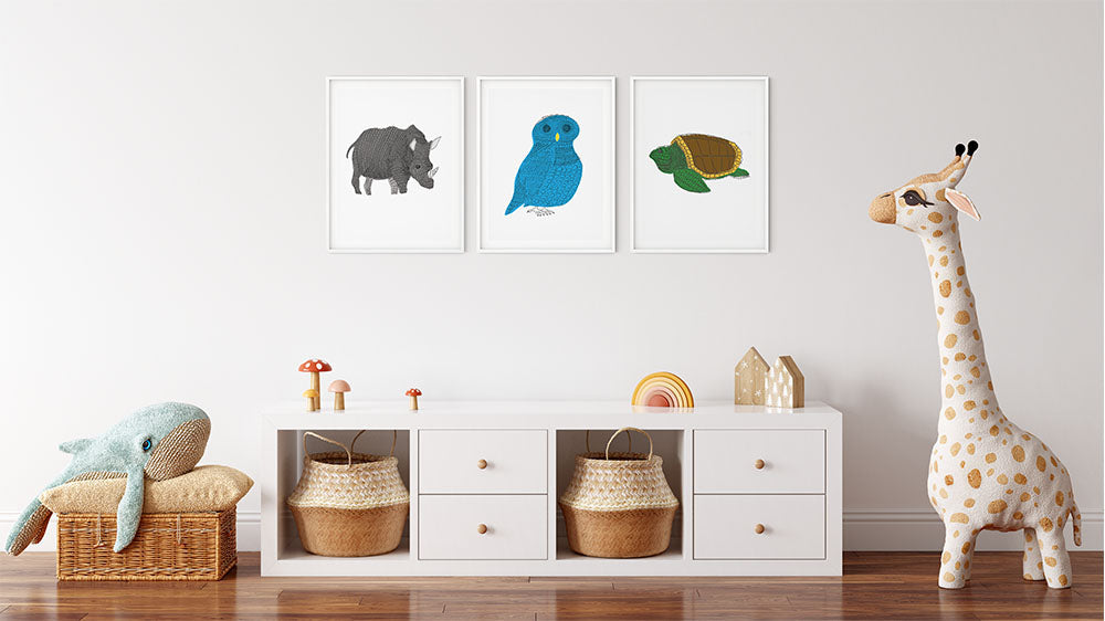 Three framed animal illustrations as nursery decor 