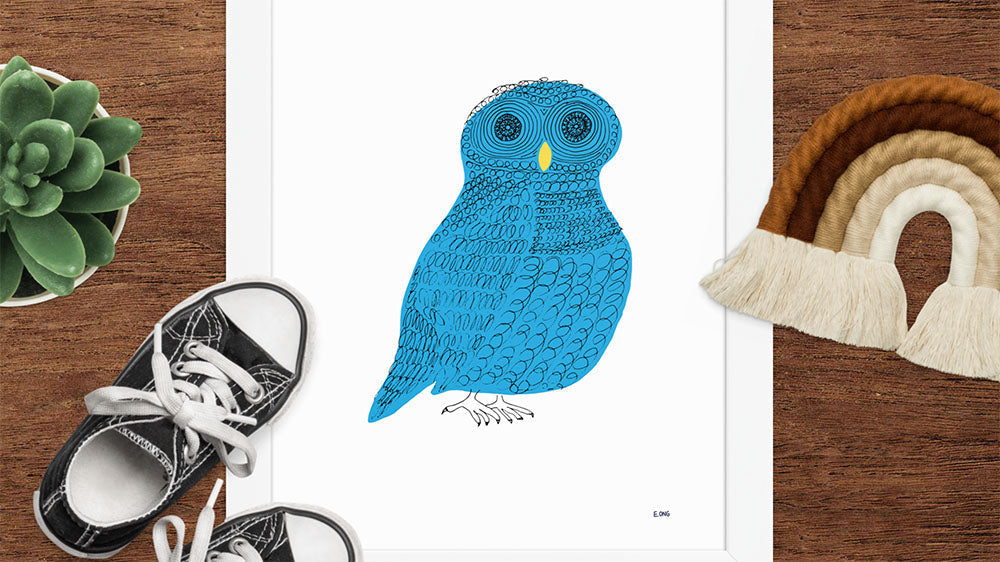 An art print of a blue owl along with other kid-friendly items.