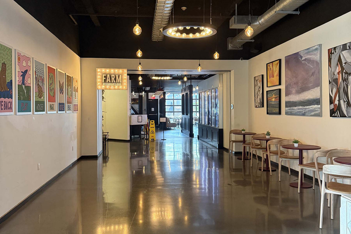 Lobby of the Hotel Nyack, with two walls facing each other that have artwork from Erwin Ong and Ken Burns