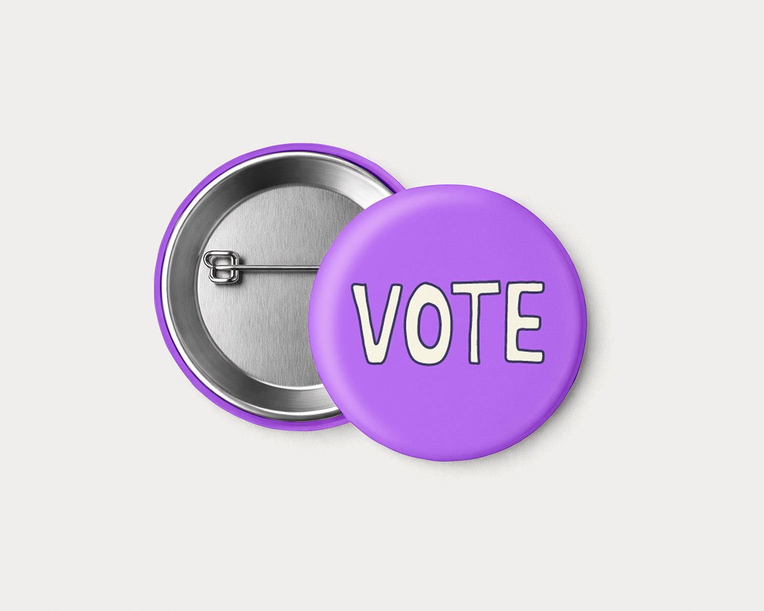 2.25-inch VOTE pinback button with cream hand-lettered text on a purple background.